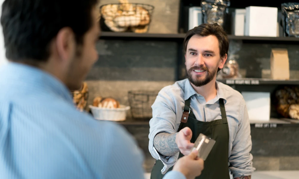 Man handing over a card to a server