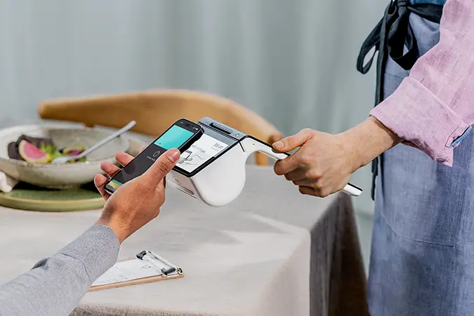 Customer using phone for a purchase