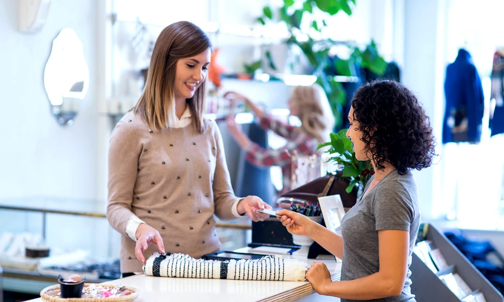 Woman paying by card at a clothing store