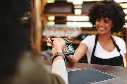 Woman tapping card to pay